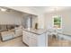 Open-concept living area with a view of the kitchen, featuring a large island and dining area at 107 S Sina St, Troutman, NC 28166