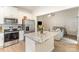 Modern kitchen with stainless steel appliances and a view of the living room for seamless entertaining at 107 S Sina St, Troutman, NC 28166