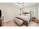Spacious bedroom with a ceiling fan, bench seat, and natural light from windows, perfect for relaxation at 107 S Sina St, Troutman, NC 28166