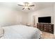 Cozy bedroom with a TV, ceiling fan, and a view into the hallway, offering comfort and convenience at 107 S Sina St, Troutman, NC 28166
