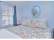 Bedroom featuring a window and paisley bedding that complements the room's light blue walls at 108 Britt Ln, New London, NC 28127