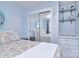 Cozy bedroom with mirrored closet doors, floating shelves, and a comfortable bed with colorful paisley bedding at 108 Britt Ln, New London, NC 28127