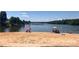 Sandy beach with a roped-off swim area where people can relax and enjoy waterfront recreation at 108 Britt Ln, New London, NC 28127