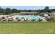 A vibrant community pool area with umbrellas and seating, perfect for summer relaxation and recreation at 108 Britt Ln, New London, NC 28127
