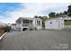 Exterior view of home with shed, gravel driveway, and screened porch, ideal for outdoor enjoyment at 108 Britt Ln, New London, NC 28127