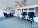 Spacious porch featuring ceiling fans, comfortable seating, and a view of the surrounding landscape at 108 Britt Ln, New London, NC 28127