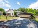 Exterior view shows house and covered parking with a long driveway at 1111 Unionville Church Rd, Monroe, NC 28110