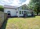 Back exterior view of home with black trimmed windows and mature trees at 1111 Unionville Church Rd, Monroe, NC 28110