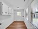 Laundry room with laminate flooring, built-in cabinets, and a view to the backyard at 1111 Unionville Church Rd, Monroe, NC 28110