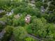 A lovely aerial view of a property nestled amongst mature trees in a residential neighborhood at 1136 S Edgemont Ave, Gastonia, NC 28054
