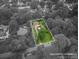 An aerial view showing approximate lot lines of a home in a leafy green neighborhood at 1136 S Edgemont Ave, Gastonia, NC 28054