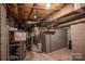 Exposed basement infrastructure including beams, wiring, and insulation at 1136 S Edgemont Ave, Gastonia, NC 28054