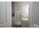 Compact bathroom featuring a shower and checkered tile floor at 1136 S Edgemont Ave, Gastonia, NC 28054