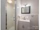 Clean bathroom with a shower, vanity, and neutral color scheme at 1136 S Edgemont Ave, Gastonia, NC 28054