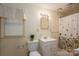 Clean and functional bathroom with a vanity sink, toilet, and shower with patterned curtains at 1136 S Edgemont Ave, Gastonia, NC 28054