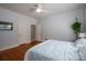 Cozy bedroom featuring hardwood floors, ceiling fan, and natural light at 1136 S Edgemont Ave, Gastonia, NC 28054
