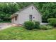 View of a well-kept back exterior with a garage, porch, and landscaped greenery at 1136 S Edgemont Ave, Gastonia, NC 28054
