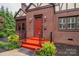 Close-up of the inviting front door of a brick home with eye-catching red steps at 1136 S Edgemont Ave, Gastonia, NC 28054