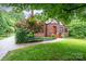 Beautifully landscaped front yard with a charming brick home and a inviting walkway at 1136 S Edgemont Ave, Gastonia, NC 28054