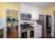 Bright kitchen with stainless steel appliances and white cabinetry, perfect for cooking and entertaining at 1136 S Edgemont Ave, Gastonia, NC 28054