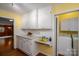 Bright kitchen with white cabinetry and adjacent laundry area, offering convenience and functionality at 1136 S Edgemont Ave, Gastonia, NC 28054