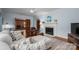 Cozy living room with hardwood floors, a fireplace, and open to the dining area at 1136 S Edgemont Ave, Gastonia, NC 28054