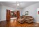 Comfortable living room with hardwood floors, ceiling fan, and decorative doors at 1136 S Edgemont Ave, Gastonia, NC 28054
