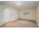 This room has new carpet, a large window, and access to the outside through a door with blinds at 1136 S Edgemont Ave, Gastonia, NC 28054