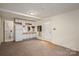 Cozy living space with a kitchenette, featuring essential appliances and carpeted flooring at 1136 S Edgemont Ave, Gastonia, NC 28054