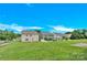 Wide shot of the neighborhood highlighting the spacious backyard with vibrant green grass and a small patio at 12217 Dearview Ln, Charlotte, NC 28269