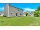 View of the home's large backyard with lush green grass, a perfect space for outdoor activities and relaxation at 12217 Dearview Ln, Charlotte, NC 28269
