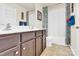 Well-lit bathroom featuring double vanity, tile flooring, and a shower-tub combination at 12217 Dearview Ln, Charlotte, NC 28269