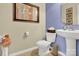 Half bath with a pedestal sink, toilet, and framed art adding charm to the space at 12217 Dearview Ln, Charlotte, NC 28269