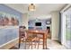 Dining area with wooden table and chairs, and view into the living room with fireplace at 12217 Dearview Ln, Charlotte, NC 28269