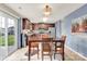 Dining area with dark wood table and chairs adjacent to the kitchen and a sliding glass door at 12217 Dearview Ln, Charlotte, NC 28269