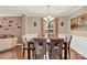 Elegant dining room with hardwood floors, a modern chandelier, and a view into the living area at 12217 Dearview Ln, Charlotte, NC 28269