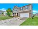 Charming two-story home with a stone facade and a spacious two-car garage on a sunny day at 12217 Dearview Ln, Charlotte, NC 28269