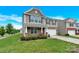 Attractive two-story home with stone facade, a two-car garage, and a well-manicured lawn at 12217 Dearview Ln, Charlotte, NC 28269