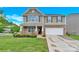 Charming two-story home with stone accents, well-maintained lawn, and attached two-car garage at 12217 Dearview Ln, Charlotte, NC 28269