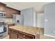 Spacious kitchen showcasing stainless steel appliances, dark cabinets, and a functional island at 12217 Dearview Ln, Charlotte, NC 28269