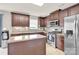 Well-lit kitchen with stainless steel appliances, tiled backsplash, and a central island at 12217 Dearview Ln, Charlotte, NC 28269