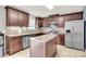 Well-equipped kitchen with stainless steel appliances, dark cabinets, and a central island at 12217 Dearview Ln, Charlotte, NC 28269