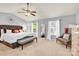Main bedroom showcasing a ceiling fan, tray ceiling, and large windows for ample light at 12217 Dearview Ln, Charlotte, NC 28269
