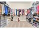 Spacious walk-in closet featuring ample shelving and hanging space for organized storage solutions at 12217 Dearview Ln, Charlotte, NC 28269