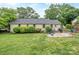 The backyard has a seating area, a grill, and a lush green lawn at 1227 Seneca Pl, Charlotte, NC 28210