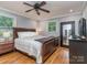 Cozy bedroom featuring hardwood floors, large windows and a decorative ceiling fan at 1227 Seneca Pl, Charlotte, NC 28210