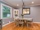 Traditional dining room area with hardwood floors, classic chandelier, and bright window at 1227 Seneca Pl, Charlotte, NC 28210