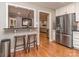 Bright kitchen featuring stainless steel appliances, wooden bar stools and hardwood floors at 1227 Seneca Pl, Charlotte, NC 28210