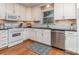 Stylish kitchen features white cabinets, stainless steel appliances, hardwood floors, and a modern backsplash at 1227 Seneca Pl, Charlotte, NC 28210
