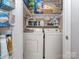 Convenient laundry room with washer, dryer, and built-in shelving for storage at 1227 Seneca Pl, Charlotte, NC 28210
